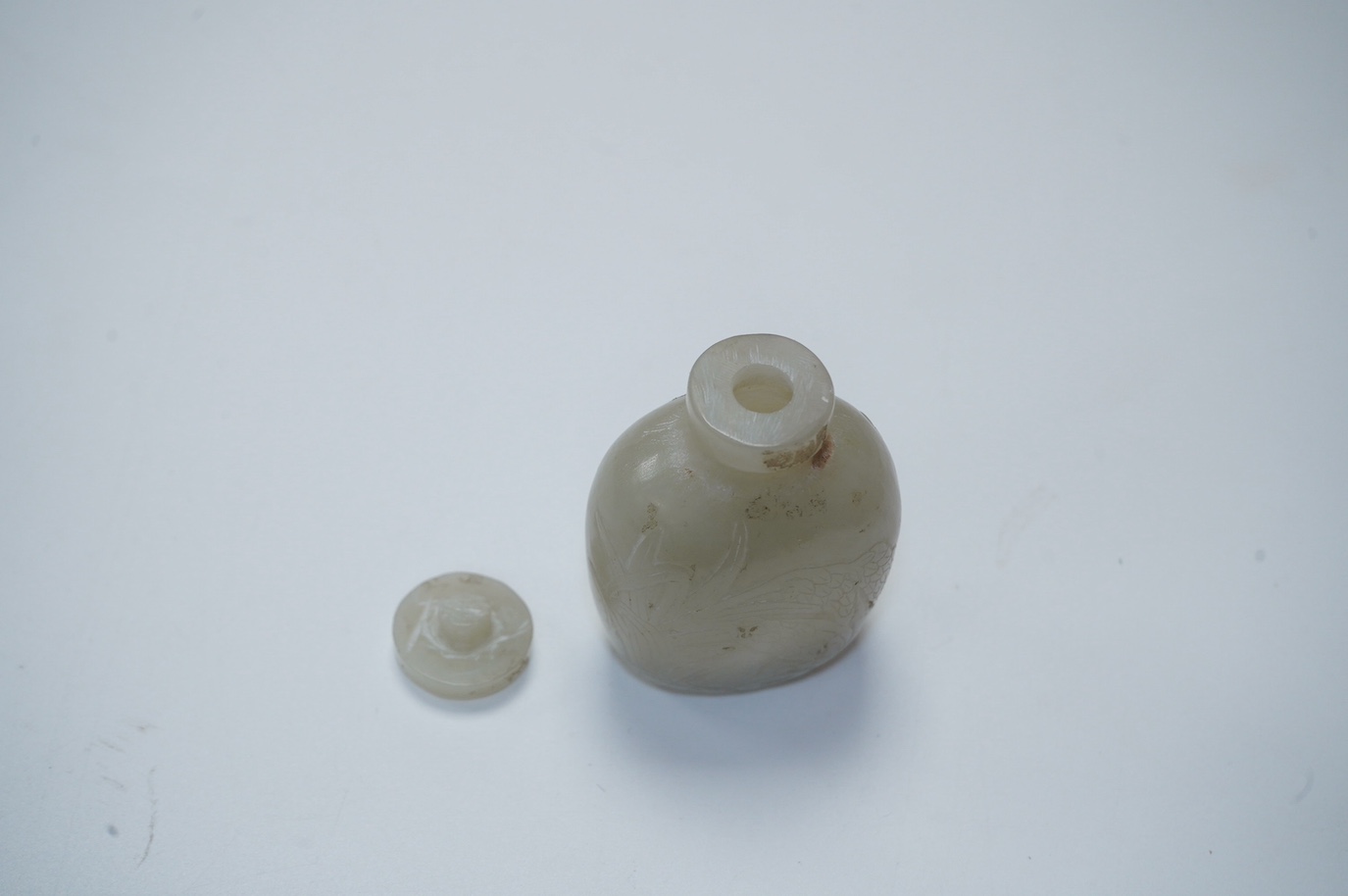 A Chinese carved jade snuff bottle with stopper, 7cm high including stopper. Condition - good